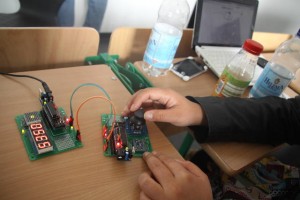 Aryeom tinkering with the devices to hack during the Reverse Engineering Workshop.